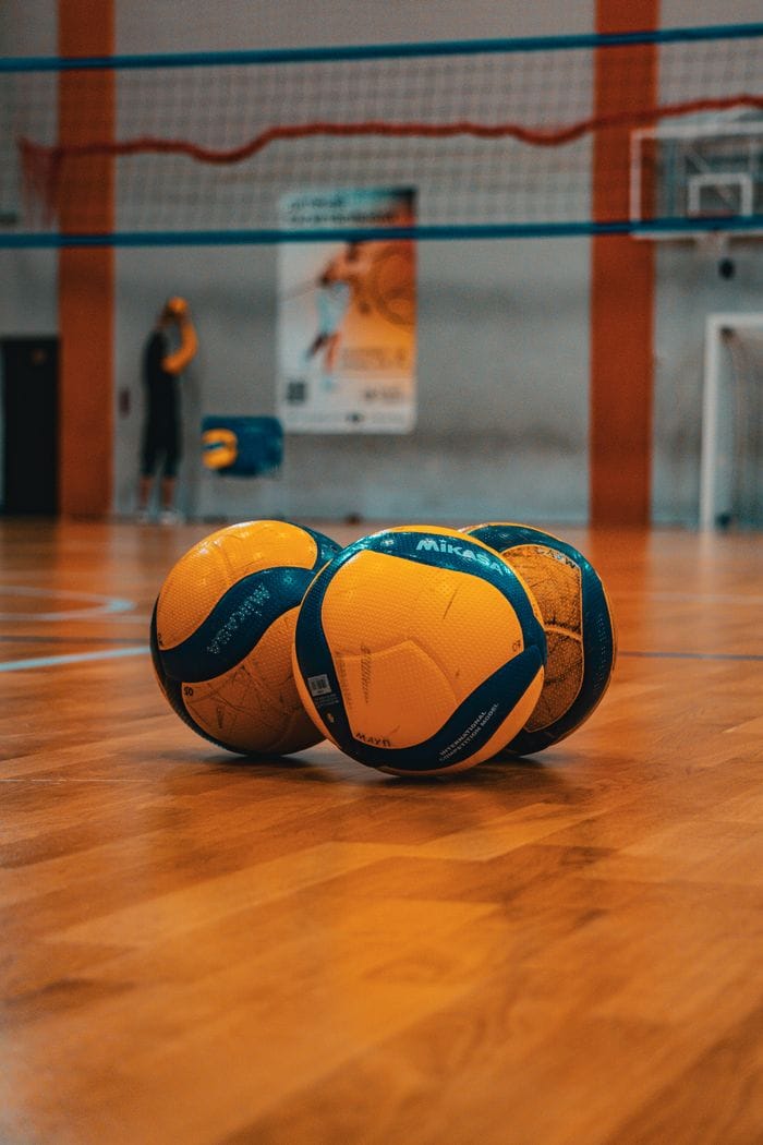 Actividades Three volleyballs on a sports court in Kyiv, Ukraine. Ideal for athletic and sports themes.